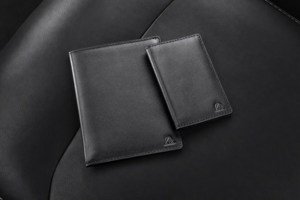 Atlas Wallet and Nexus Wallet in Onyx full-grain leather on a black leather seat.