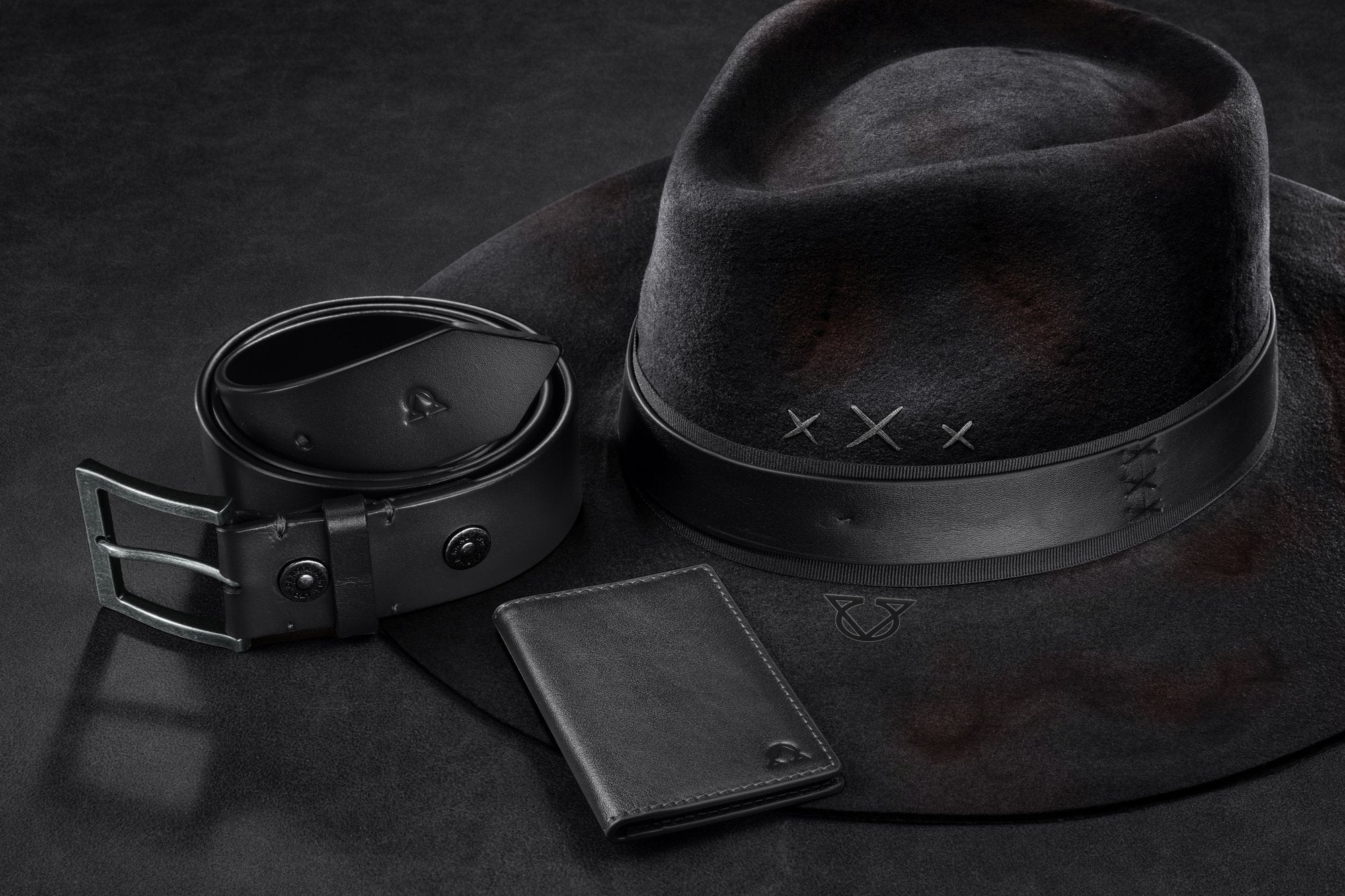 A leather belt, bifold wallet, and wool felt hat in black — DARMA