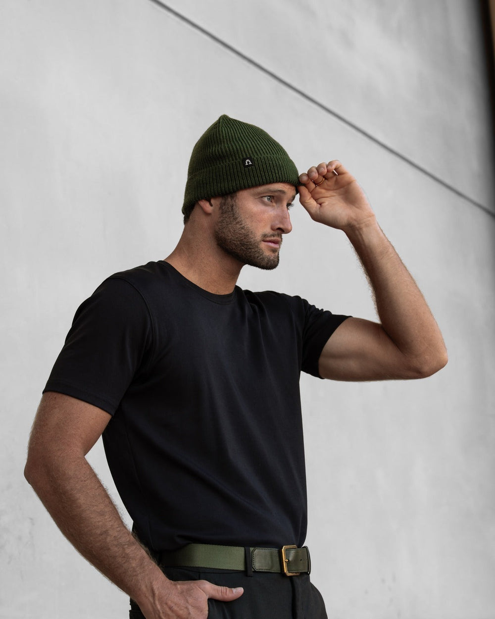 Solis Beanie in Cypress worn with a black tee.