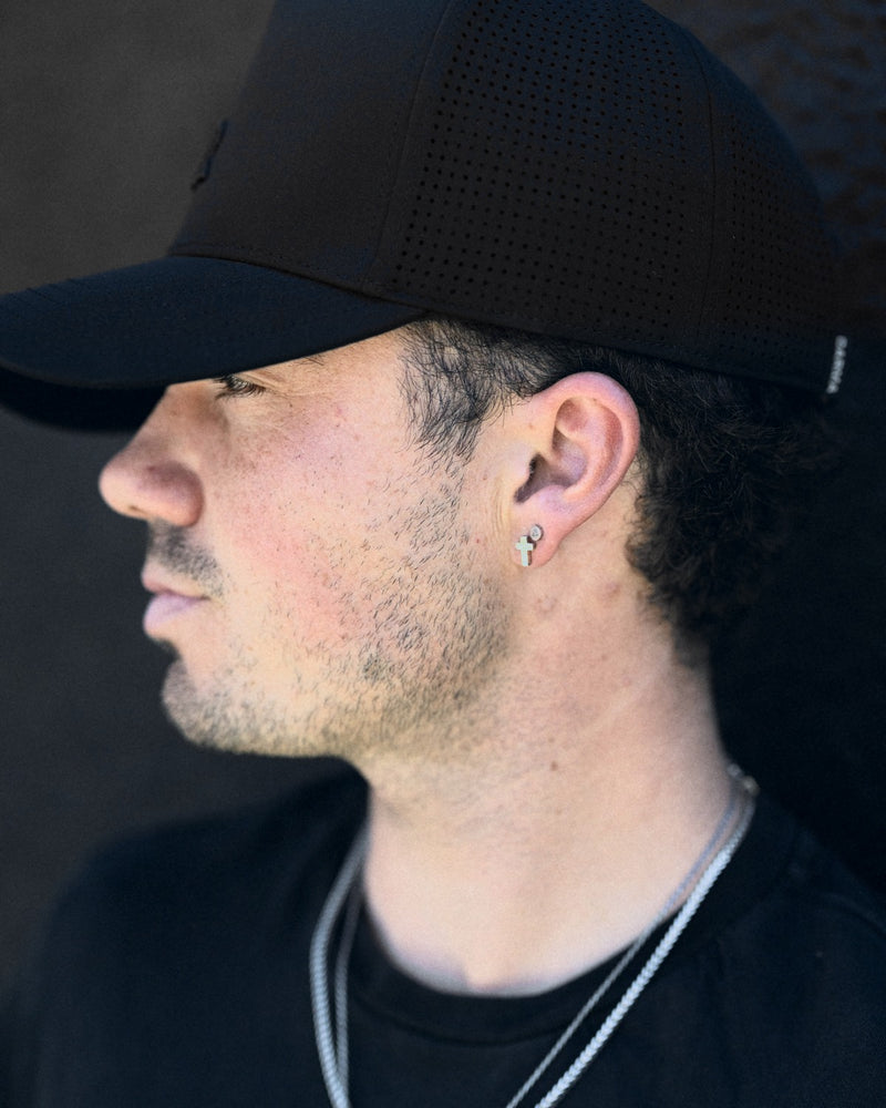 Lux Trucker hat in Onyx, seen in profile, silver chains at the neck.