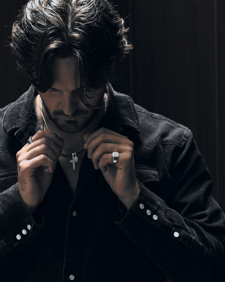 Primis Finis dog tags in 925 sterling silver, worn under a black denim jacket.