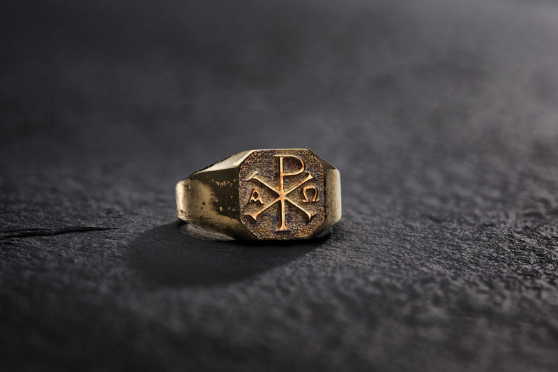 ChiRho signet ring in 24K gold vermeil on dark stone.