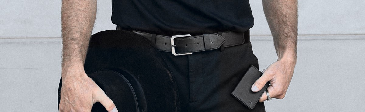 Belt in Onyx and a wallet in Onyx at the waist.